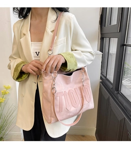Pink tote bag detail with embossed TIOHO lettering and leather chain shoulder strap