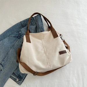 Retro canvas tote bag in cream and brown, featuring a wide shoulder strap and dual handles