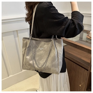Detail view of silver grey marble texture tote bag with stylish chain and bead accents