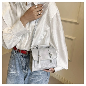 Silver metallic crossbody bag with textured faux leather finish and double magnetic closure
