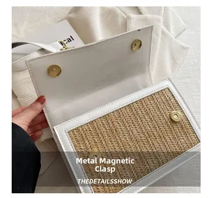 Detail of the golden magnetic hardware buckle on the woven leather handbag