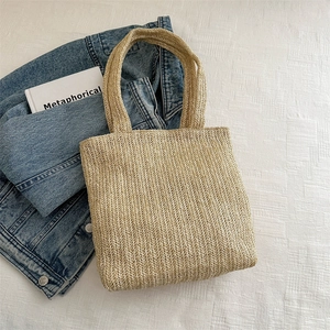 Woven beige straw tote bag with textured wave pattern for summer beach vacations