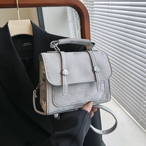 Silver-grey minimalist crossbody square bag with metallic finish and magnetic snap closure