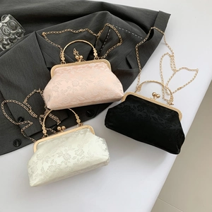 Three-piece set of vintage floral brocade evening bags with gold metal clasps and chain straps