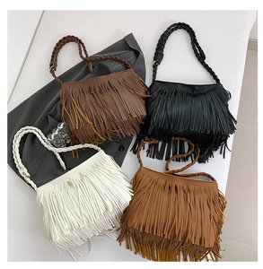 Detail of four colorful tassel shoulder bags with woven handles and leather textures
