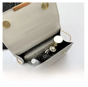 Internal capacity of white quilted crossbody bag with golden chain and magnetic buckle