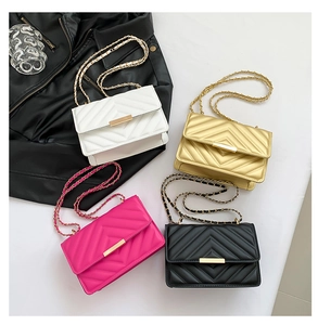 Detail of four quilted chain bags in white, gold, rose and black with metal locks