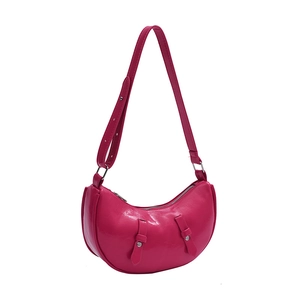 Magenta crescent shoulder bag with adjustable strap and silver-tone buckles on white background