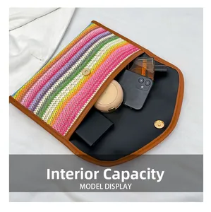 Internal capacity of rainbow woven clutch showing space for phone and cosmetics