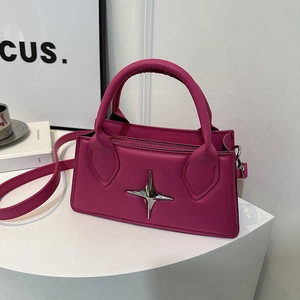 Minimalist fuchsia crossbody bag with silver star ornament on white platform