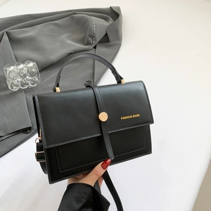 Fashionable black faux leather crossbody bag with gold hardware and top handle