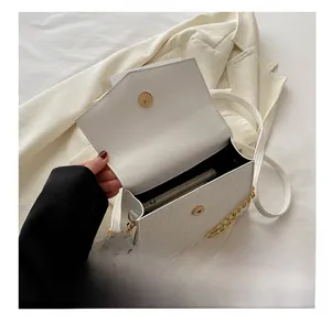 Internal view of white croc-embossed bag showing capacity for a smartphone