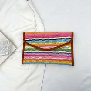 Ethnic style striped woven envelope clutch with colorful patterns and brown leather trim