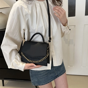 Elegant black crossbody bag with crocodile pattern and gold chain strap for women