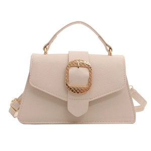 Chic beige lychee leather trapezoid handbag with decorative gold square buckle and strap