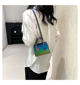 Detail of gradient metallic quilted handbag showing crossbody strap and mini box shape