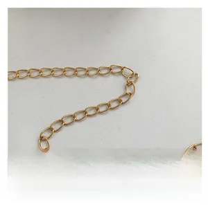 Close-up of golden metal chain strap with oval links for a mini fashion shoulder bag
