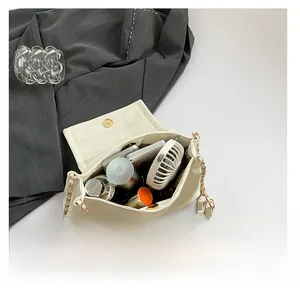 Macro view of the cream leather bag interior showing large capacity for daily essentials