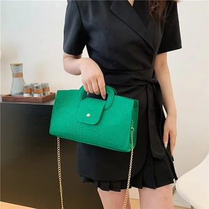 Retro crocodile pattern green handbag with gold chain strap shown on model outfit