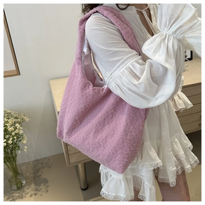 Detail of pink pleated tote bag with 3D bubble texture and wide shoulder strap