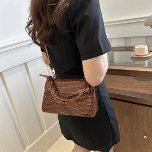 Brown crocodile pattern shoulder bag for women with glossy finish and gold hardware
