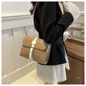 Détail du petit sac carré kaki avec bandoulière contrastée blanche et boucle en métal