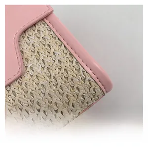 Close-up of pink leather trim and natural woven straw material with fine stitching