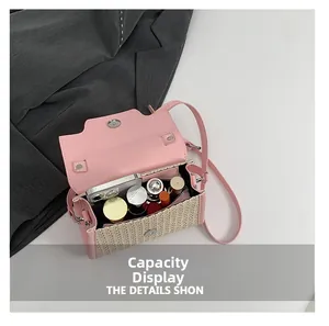Top view of pink leather straw bag interior showing storage for phone and lipsticks