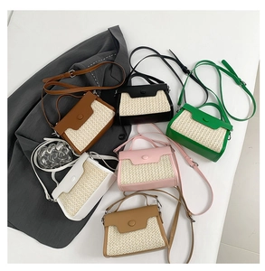 Flat lay of multiple woven straw and leather crossbody bags in six assorted colors