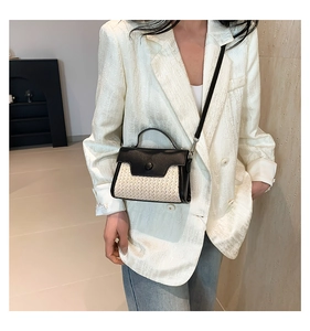 Chic two-tone crossbody bag with black leather flap and beige woven texture detail