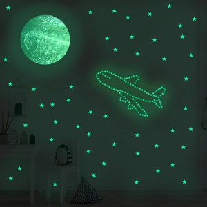 Luminous moon and stars wall stickers glowing in a dark kid's room with airplane shape