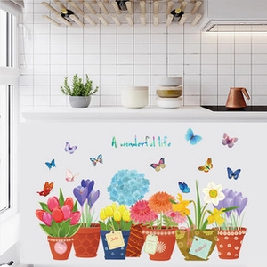 Detail of floral wall decals featuring tulips and butterflies on white kitchen tiles