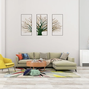 Modern three-panel gold and green tree wall art with black frames above living room sofa