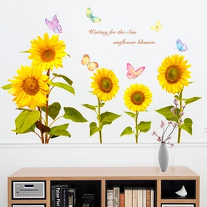 Detail view of sunflower wall decals with butterflies and Waiting for the Sun text
