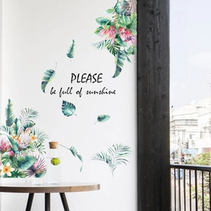 Close-up of botanical wall stickers with watercolor tropical leaves and floral patterns