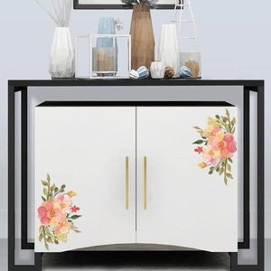 Floral watercolor wall stickers with pink and orange flowers on a white cabinet surface