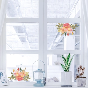 Detail of floral watercolor window stickers with pink blooms on a white frame