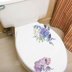 Detail of floral toilet lid decals featuring hydrangea flowers and elegant purple ribbons