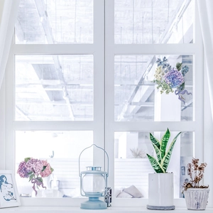 Close-up of watercolor hydrangea window stickers with pink and blue floral clusters