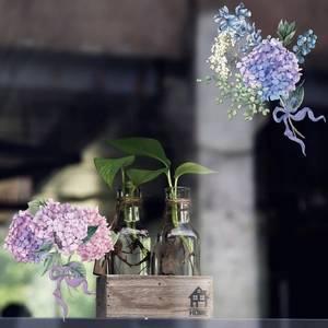 Detail of hydroponic glass vases in a rustic wooden box with HOME print and hemp rope