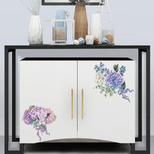 Detail view of pink and blue hydrangea floral stickers with purple ribbons on white cabinets