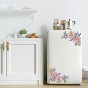 Detail of vintage pink rose and purple flower corner stickers on a white refrigerator