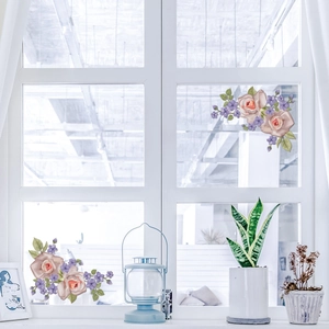 Detailed view of floral window decals featuring pink roses and purple flowers on glass