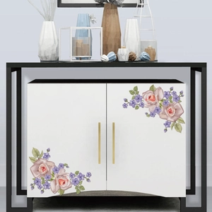 Detailed view of floral decals featuring pink roses and green leaves on a white cabinet