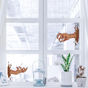 Creepy zombie hand window stickers for Halloween decor on bright glass panels