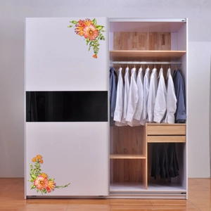 Detail of a white sliding wardrobe with colorful floral decals and wood interior