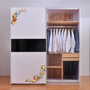Detailed view of Christmas stickers on a modern white wardrobe with internal wood grain texture