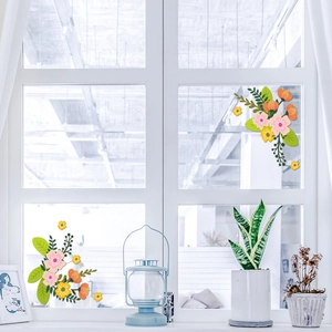 Detail of floral Christmas window stickers with pink and orange flowers on glass