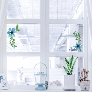 Detailed blue floral embroidery sticker set displayed on a white lattice window pane