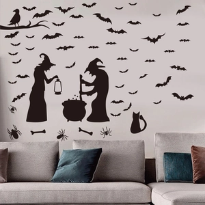 Halloween witch and bats silhouette wall decal set above a modern gray sofa